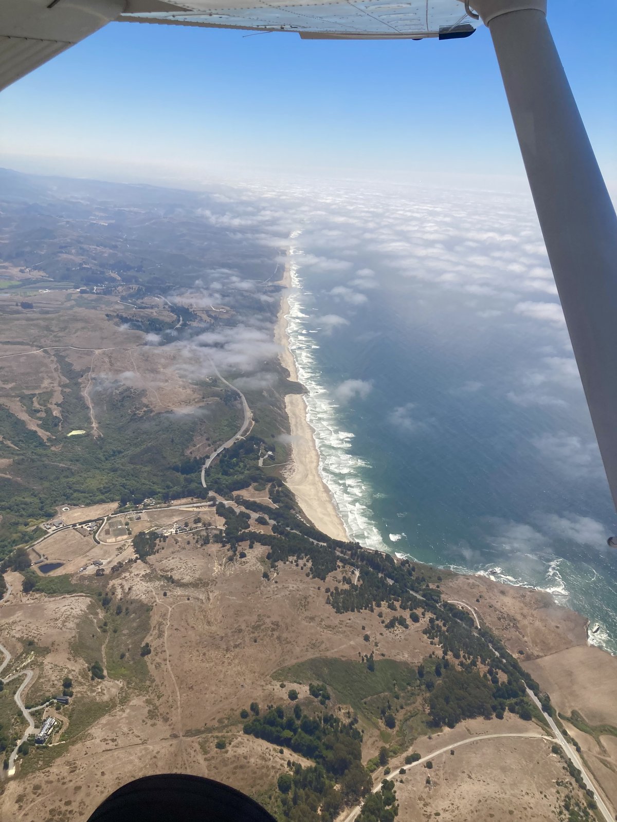 View from the cockpit of a Cessna over the California coast
